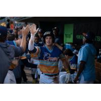 Austin Overn of the Montgomery Biscuits receives congratulations in the dugout