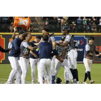 Columbia Fireflies celebrate with Jhosmmel Zue after his game-winning hit
