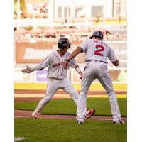 Tsung-Che Cheng of the Worcester Red Sox is congratulated by Manager Iggy Suarez