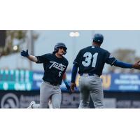 Tulsa Drillers' bench coach Johan Garcia congratulates Jake Gelof as he rounds the bases
