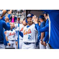 Matt Rudick is congratulated by Syracuse Mets teammates in the dugout