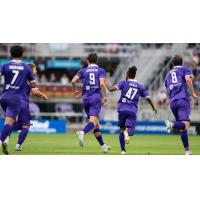 Louisville City FC's Ray Serrano, Chris Donovan, Mukwelle Akale, and Taylor Davila on the field