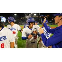 Frank Rodriguez of the Tulsa Drillers is greeted after scoring the winning run