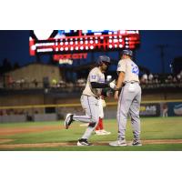 Pensacola Blue Wahoos' Xavier Meachem congratulated by manager Nelson Prada