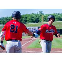 Lincoln Saltdogs outfielder Jake Hjelle (21) congratulates infielder Calyn Halvorson