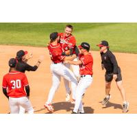 Fargo-Moorhead RedHawks mob Aidan Byrne after his walk-off sacrifice bunt